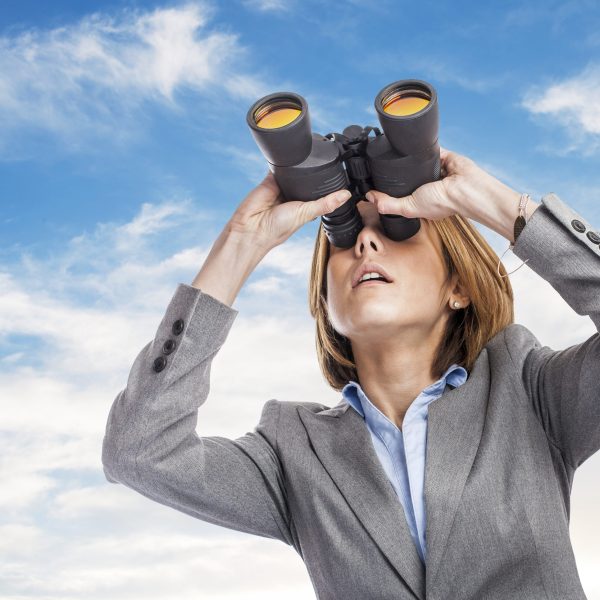 portrait of an executive young woman looking through the binoculars