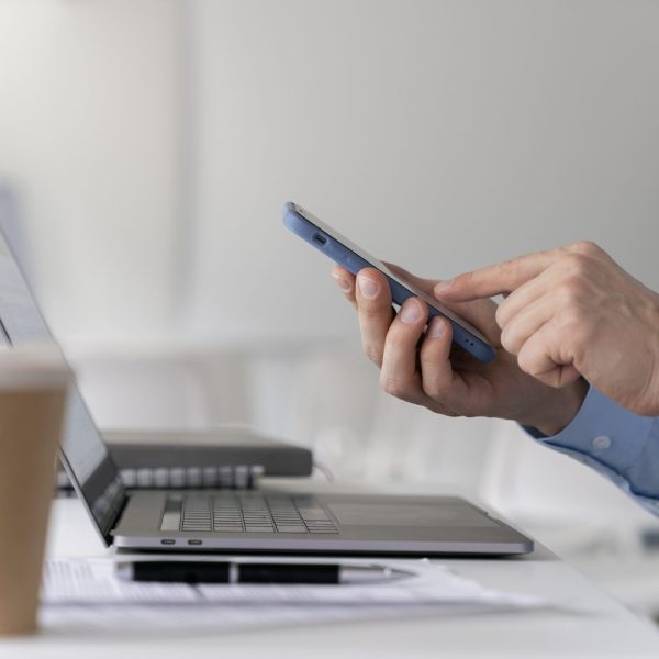 young-business-man-working-her-desk-with-laptop-smartphone